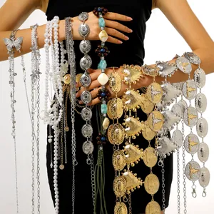 Close-up view of various bohemian style women's waist chains and decorative silver belts