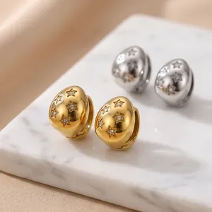 Close-up of 18K gold plated stainless steel teardrop earrings with star pattern detail.