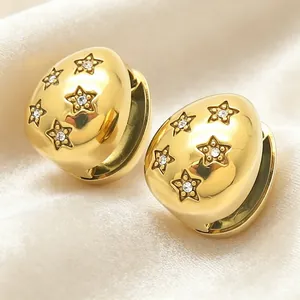 Close-up of 18K gold plated teardrop earrings with sparkling crystal star details