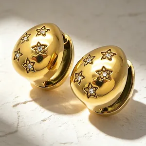 Macro view of luxurious gold-plated star earrings featuring sparkling rhinestones