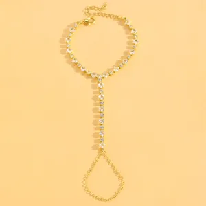 Elegant gold slave bracelet featuring sparkling square crystal links on a yellow backdrop