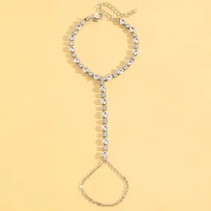 Close-up detail of a silver-toned slave bracelet featuring elegant square crystal links