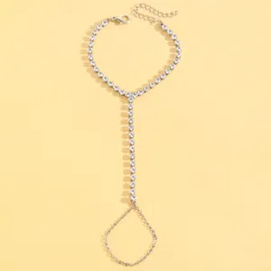 Close-up detail of an elegant silver chain hand harness with sparkling crystal rhinestones