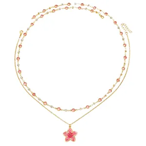 Exquisite close-up showing the pink enamel cherry blossom pendant and sparkling crystal necklace