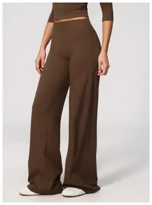 Detailed view of brown wide-leg yoga pants featuring a high-waisted design and soft texture