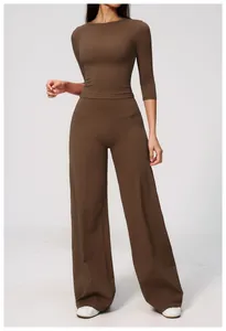 Professional model wearing a brown two-piece sports yoga set with wide-leg trousers