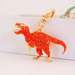 Sparkling orange rhinestone dinosaur keychain charm with elegant gold-plated metal finish