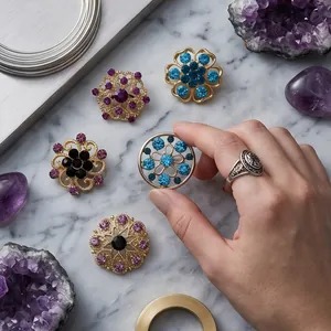 Elegant flower alloy brooches with colorful rhinestones presented on marble surface
