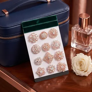 Elegant 12-piece floral brooch set with sparkling rhinestones in rose gold finish.