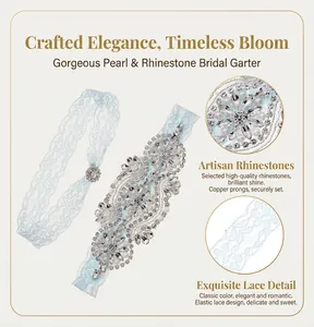 Detail of bridal garter showing hand-sewn rhinestones, pearls, and light blue lace texture.