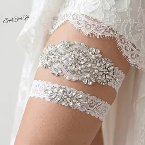 Elegant bridal garter set with hand-stitched rhinestones and pearls on white lace