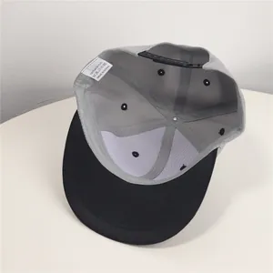 Close-up interior detail of color-block snapback cap featuring 100% acrylic wash label