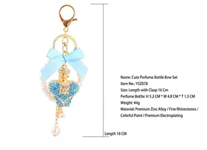 Detailed view of heart perfume bottle keychain with blue bow and pearls