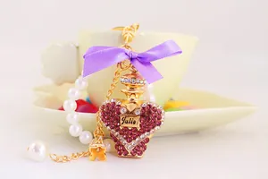 Detail view of heart-shaped perfume bottle keychain with purple bow and rhinestones