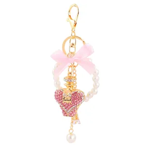 Elegant crystal heart perfume bottle keychain with pink ribbon bow and pearl ring