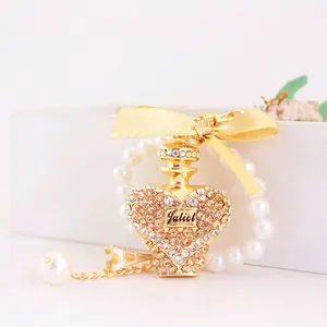 Elegant crystal heart perfume bottle keychain featuring a gold bow and pearl bracelet