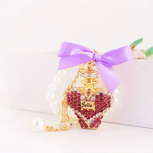Elegant heart-shaped crystal perfume bottle keychain with a purple bow and pearl chain.