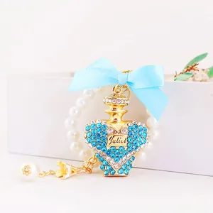 Exquisite blue crystal heart perfume bottle keychain featuring a light blue ribbon bow and pearls