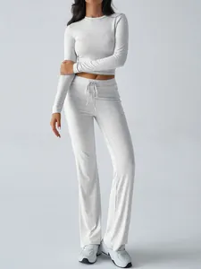 Two-piece grey loungewear set featuring a long-sleeved crop top and wide-leg trousers.