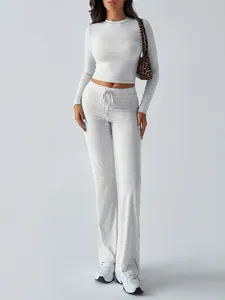 Full view of light gray long sleeve crop top and matching wide leg yoga pants set