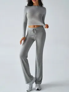 Women's grey 2-piece yoga set featuring long sleeve crop top and drawstring flare pants.