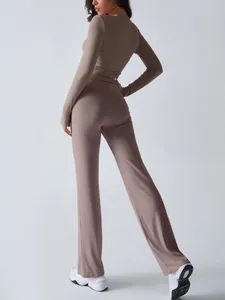 Detailed back view of a slim-fit taupe long-sleeved yoga top and matching trousers