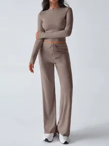 Two-piece women's lounge set featuring long-sleeve crop top and wide-leg drawstring pants
