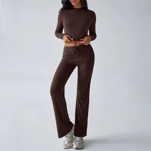 Stylish women's coffee brown two-piece yoga set with long sleeve crop top and flared pants