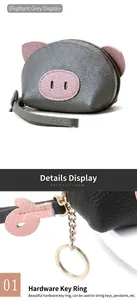 Close-up detail of the durable gold-tone hardware keychain on a pig-shaped leather coin purse.