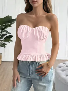 Close-up view of pink Y2K ruffle hem tube top vest on a model in a modern room
