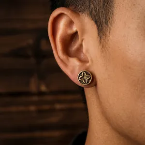 Vintage antique bronze clover stud earring shown on a male model's ear in close-up shot