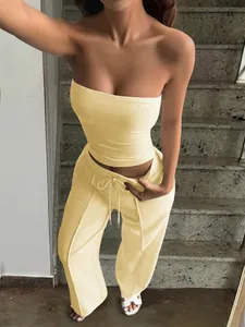 Detail view of cream two-piece lounge set with tube top and drawstring pants