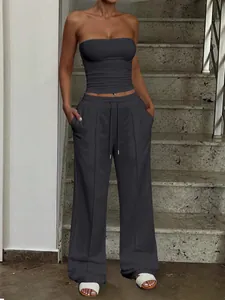 Detail view of women's grey two-piece set with tube top and wide-leg drawstring pants