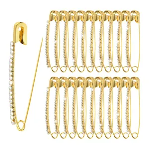 Lot d'épingles de sûreté dorées avec zircons pour resserrer la taille et décoration.