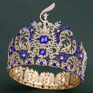 Detailed view of an oversized gold Baroque crown with royal blue and clear crystals.