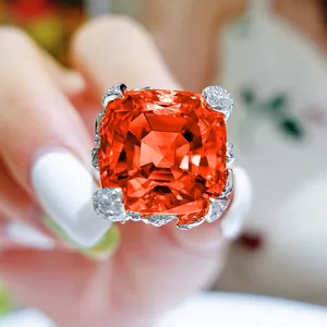 Detailed macro shot of a vibrant Asscher cut orange gemstone ring with flower setting