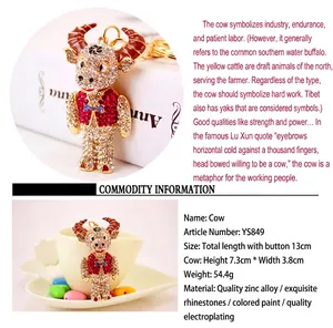 Detailed view of sparkling rhinestone bull keychain with size and material specifications