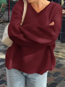 Close-up view of the burgundy V-neck knit sweater with soft and cozy texture