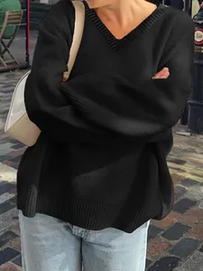 Close-up detail of a casual black V-neck knit sweater with a comfortable loose fit