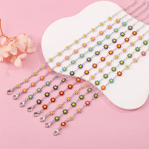 Detailed macro view of colorful enamel daisy flower bracelets with silver-tone link chains