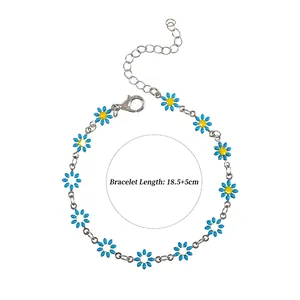 Detailed view of blue and yellow daisy charm bracelet with adjustable silver chain