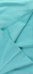Detailed close-up showing the high-quality stitching and soft fabric of turquoise jumpsuit