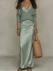 Elegant sage green knit sweater paired with a matching satin slip dress detail