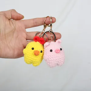 Handmade crochet animal keychains set featuring a pink pig and yellow chick design