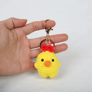 Handmade crochet yellow chick keychain charm for bags with detailed knit texture