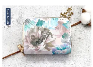 Detail of floral double-zipper card holder in ink green finish