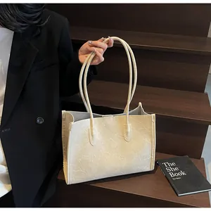 Beige crinkled leather tote bag for women, stylish large capacity shoulder bag for work.