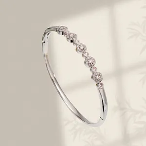 Elegant silver plated bangle featuring pink zircon petal clusters and a minimalist design