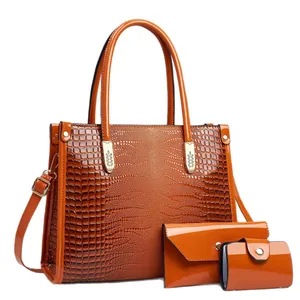 Stylish 3-piece orange crocodile pattern handbag set including shoulder bag and clutch