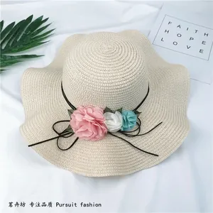 Elegant wide brim foldable straw sun hat with decorative fabric flowers for women